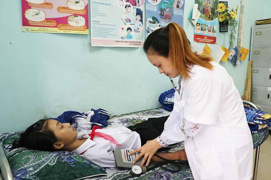 Nhân viên y tế trường học phải làm nhiều việc nhưng đồng lương hợp đồng khá ít ỏi. Ảnh: Ngọc Minh