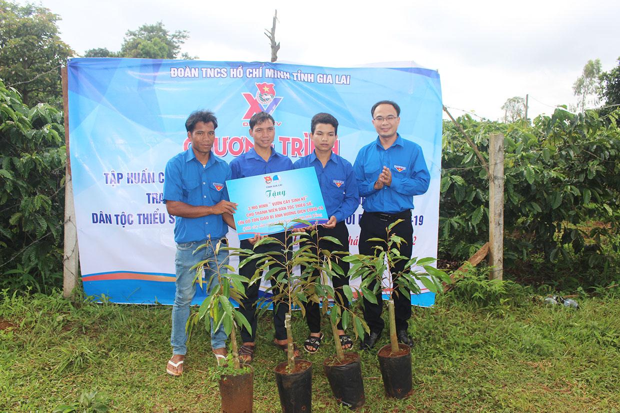 Anh Đỗ Đức Thanh (bìa phải)-Phó Bí thư Tỉnh Đoàn, Phó Chủ tịch Hội LHTN Việt Nam tỉnh tặng mô hình sinh kế cho 3 thanh niên của làng O Yố (xã Ia Băng, huyện Đak Đoa). Ảnh: Phan Lài